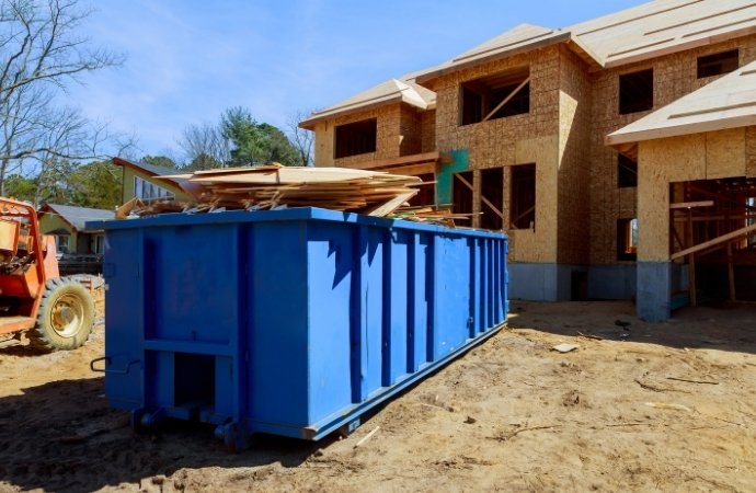 blue dumpsters placed in a house renovation