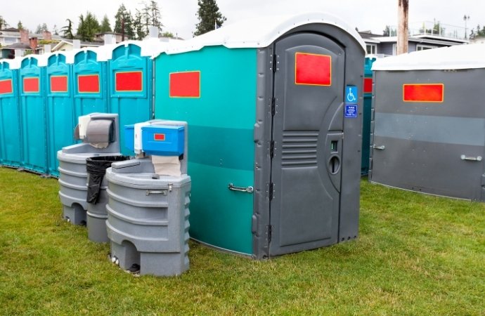 deluxe portable toilets in a field