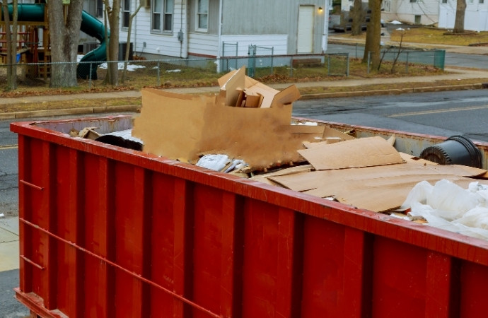 red dumpster full of trash