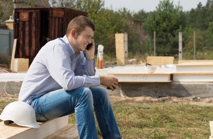 engineer calling for a portable toilet