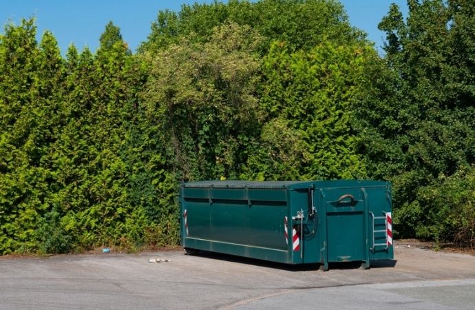 green dumpster placed in uvalde park