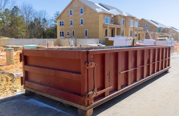 red dumpster placed in a construction site in floresville area
