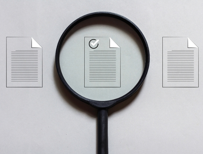 magnifying glass put over the top of documents