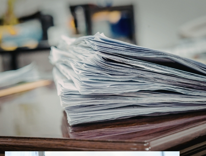 stack of license documents on top of table