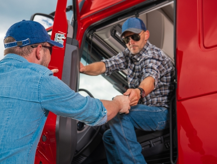 previous trucker handing over the key to next trucker