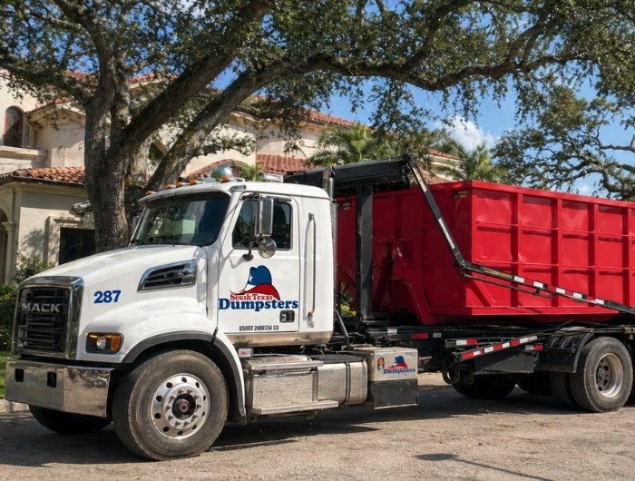 south texas dumpsters truck below a tree